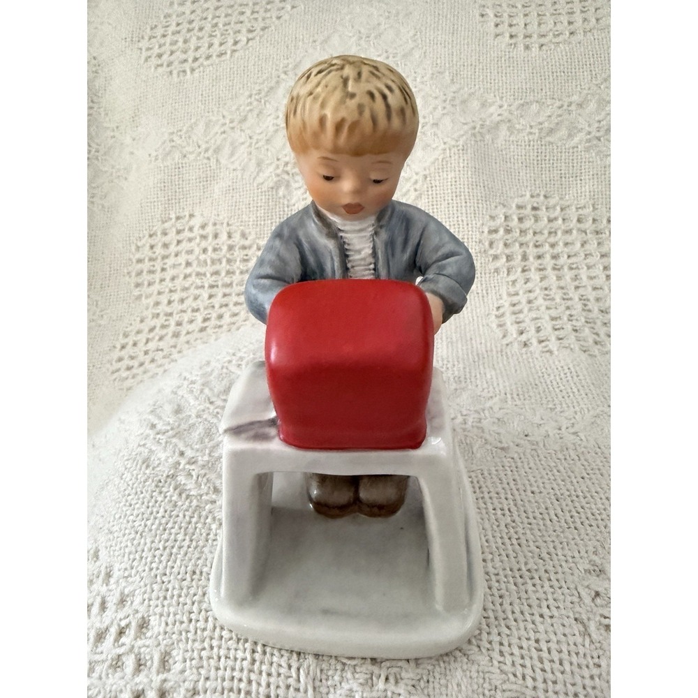 Goebel Boy Sitting On Bench With computer On Desk